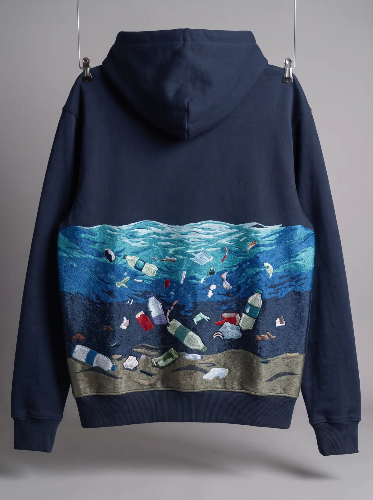 Plastic Soup Hoodie, back with embroidered ocean and plastic waste